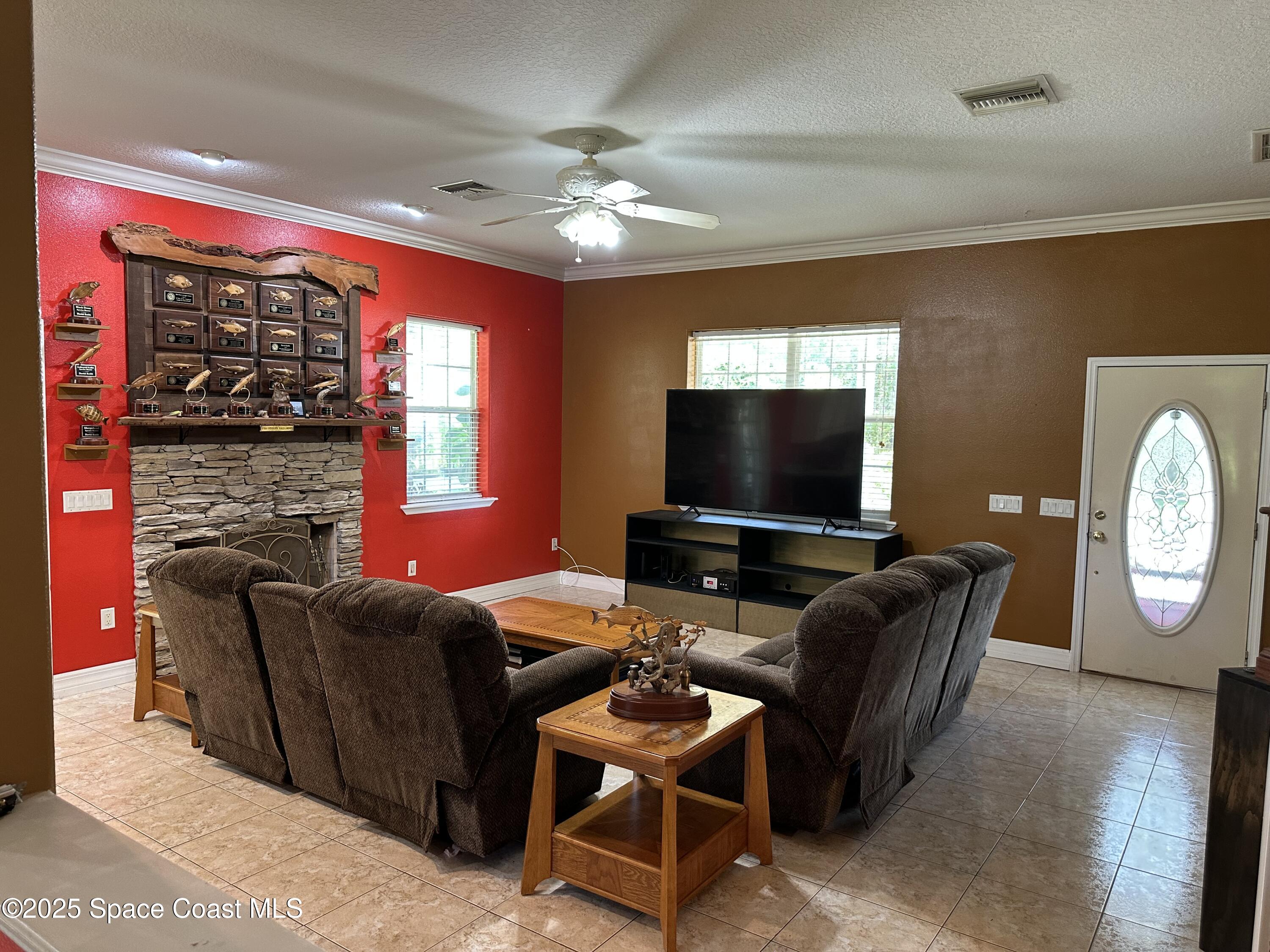 3931 U.S. Rte 1 Mims, FL 32754 - Photo 16 of 47 a living room with furniture a large window and a flat screen tv