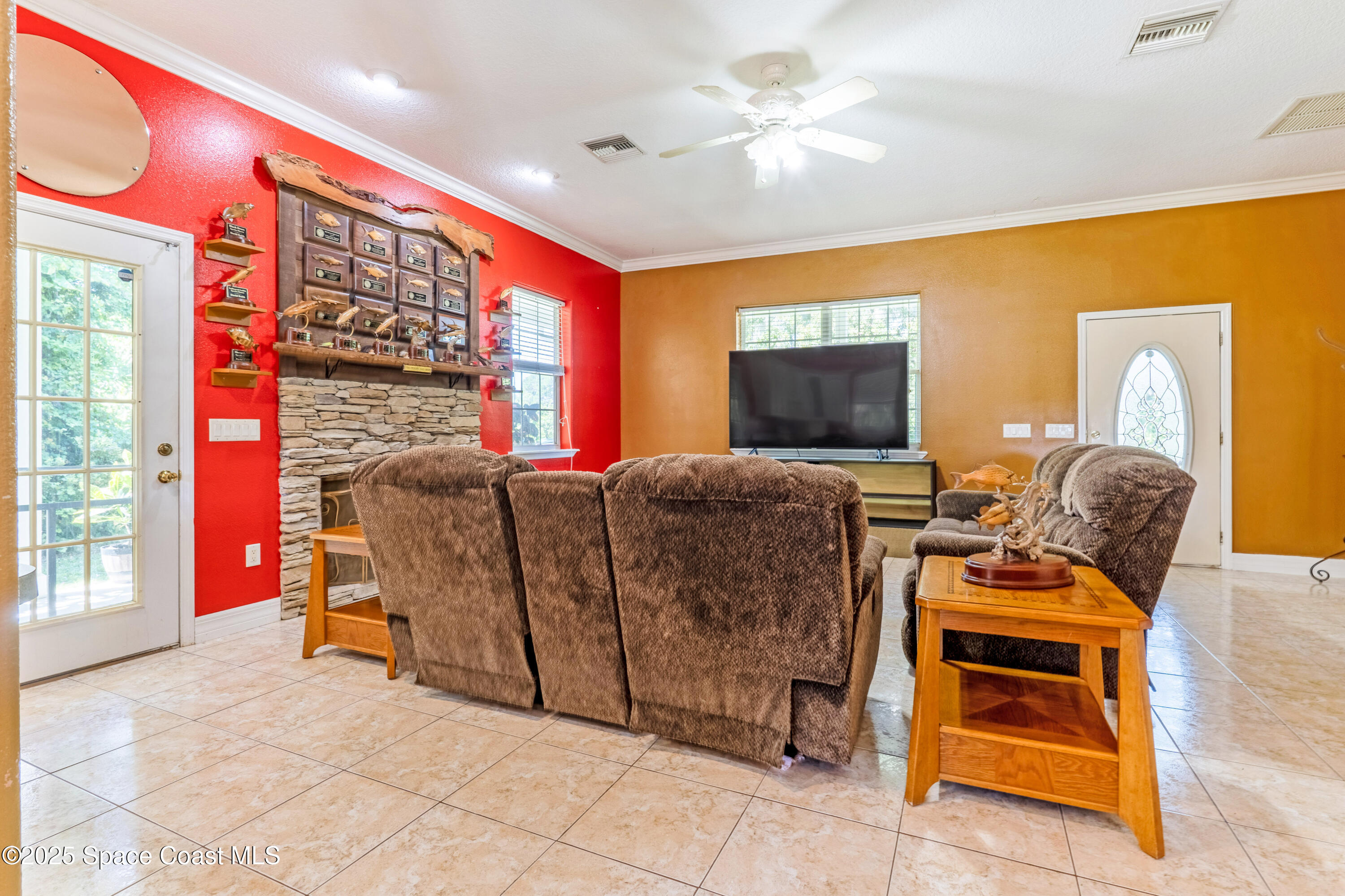 3931 U.S. Rte 1 Mims, FL 32754 - Photo 17 of 47 a living room with furniture and a flat screen tv