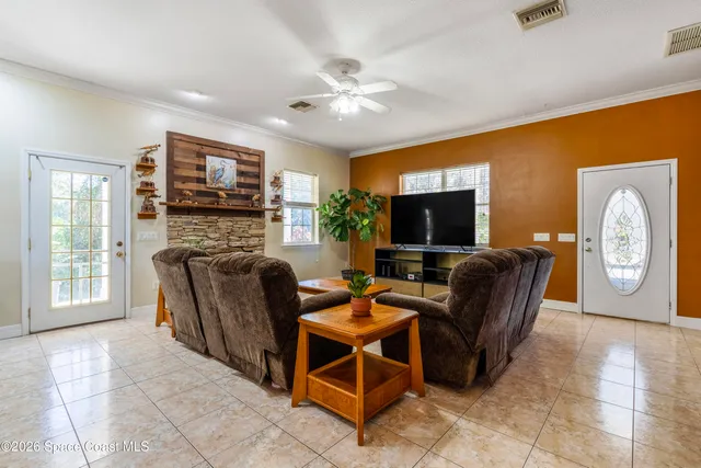 a living room with furniture a flat screen tv and a fireplace