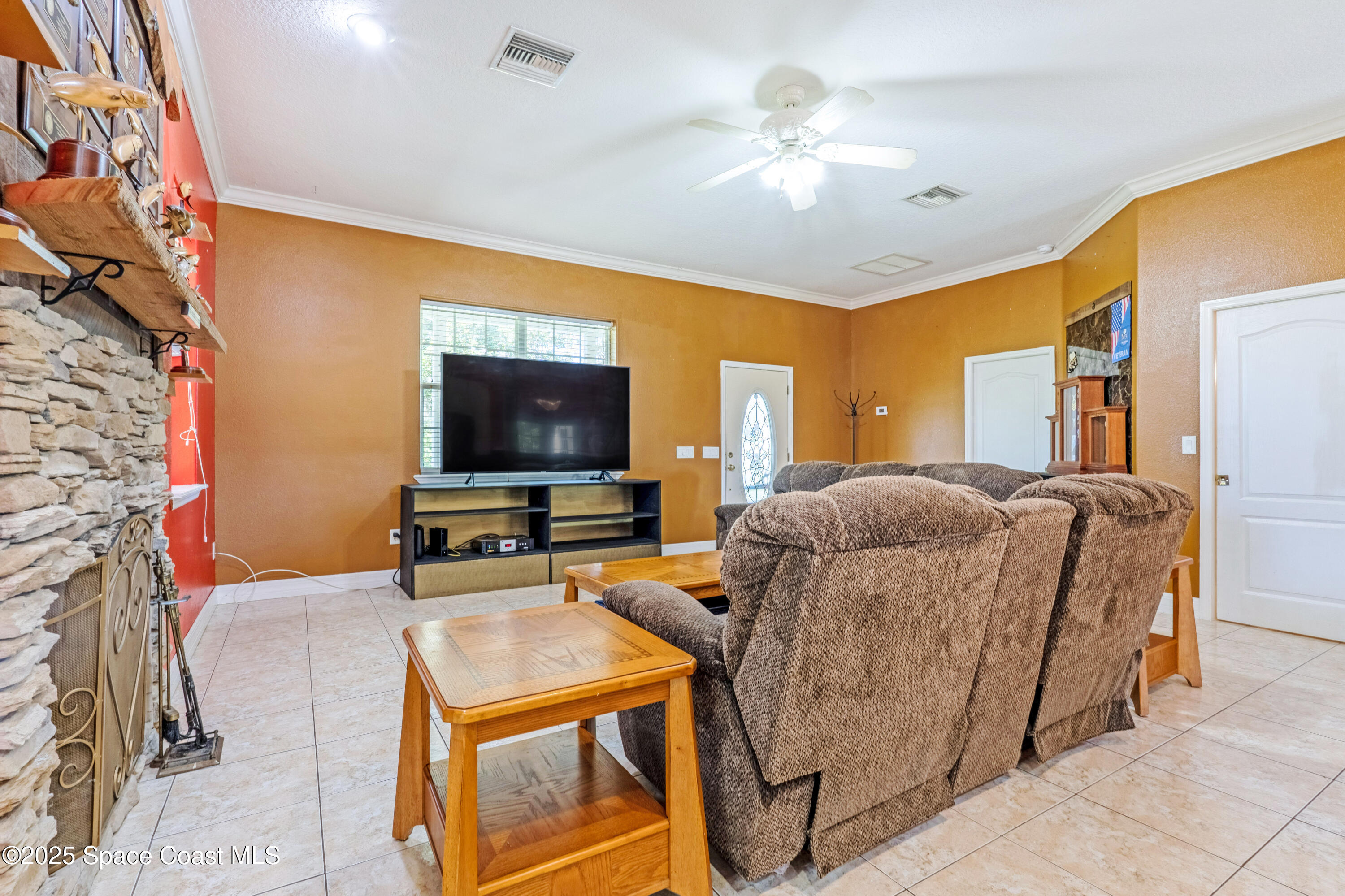 3931 U.S. Rte 1 Mims, FL 32754 - Photo 18 of 47 a living room with furniture and a flat screen tv