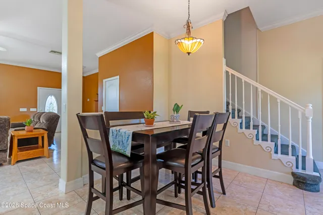 a view of a dining room with furniture and chandelier