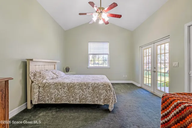 a bedroom with a bed dresser and a window