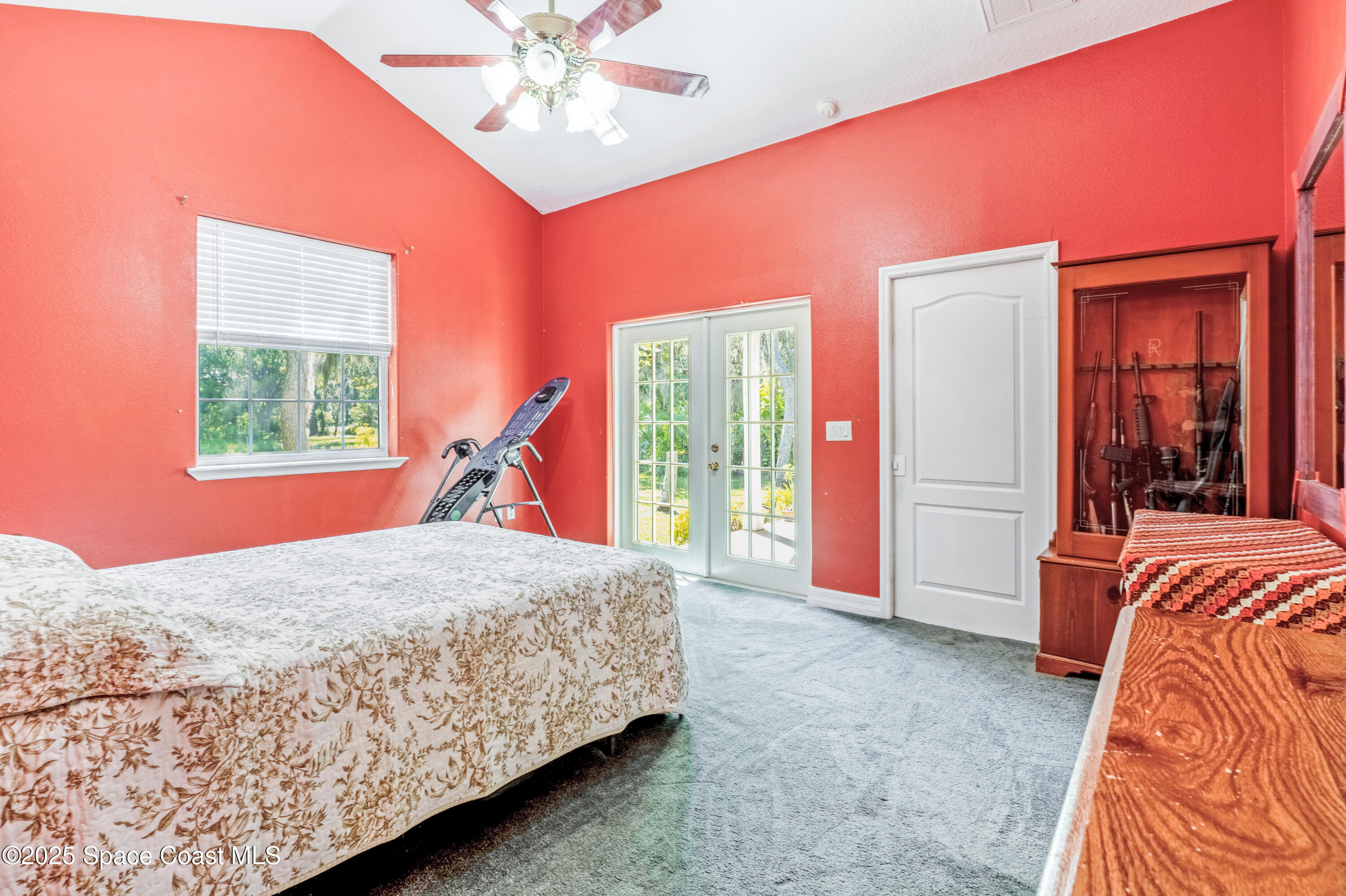 3931 U.S. Rte 1 Mims, FL 32754 - Photo 25 of 47 a bedroom with a bed and a chandelier