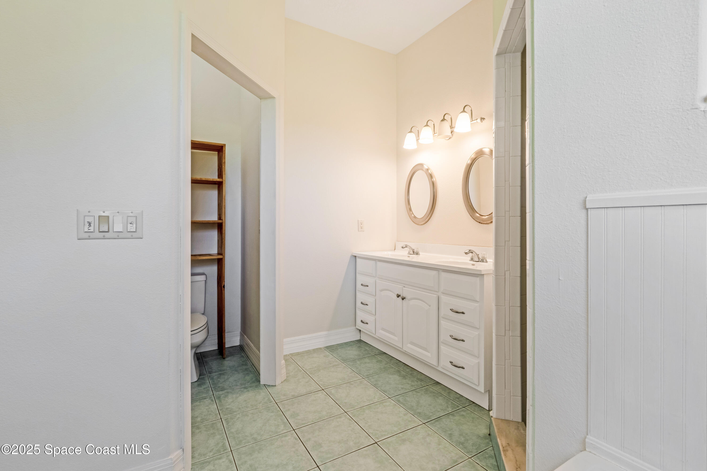 3931 U.S. Rte 1 Mims, FL 32754 - Photo 29 of 47 a spacious bathroom with a double vanity sink and a mirror