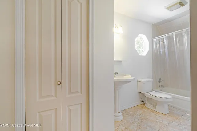 a bathroom with a toilet a sink and a mirror