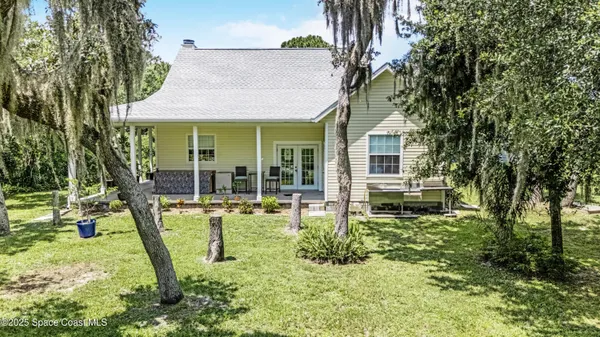 a view of a house with backyard porch and sitting area