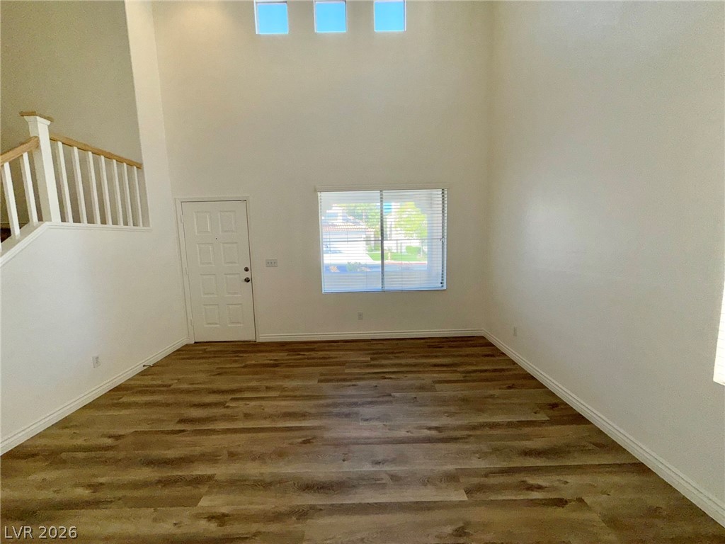9729 Trail Rider Drive Las Vegas, NV 89117 - Photo 4 of 26 A grand entrance with soaring ceilings and rich wood-look flooring greets visitors.