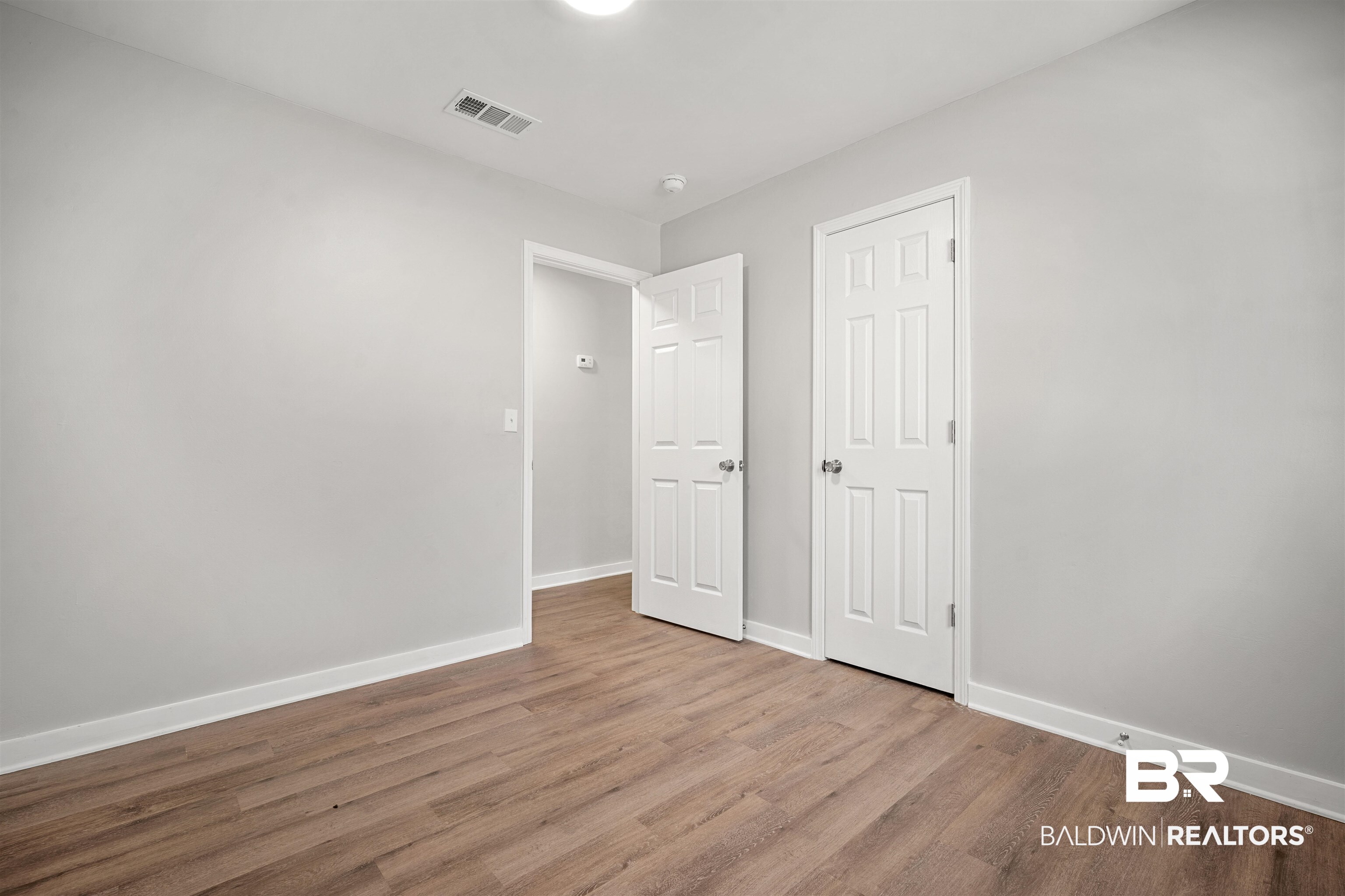 1368 Hubert Pierce Road Mobile, AL 36608 - Photo 17 of 25 Unfurnished bedroom featuring wood finished floors and baseboards