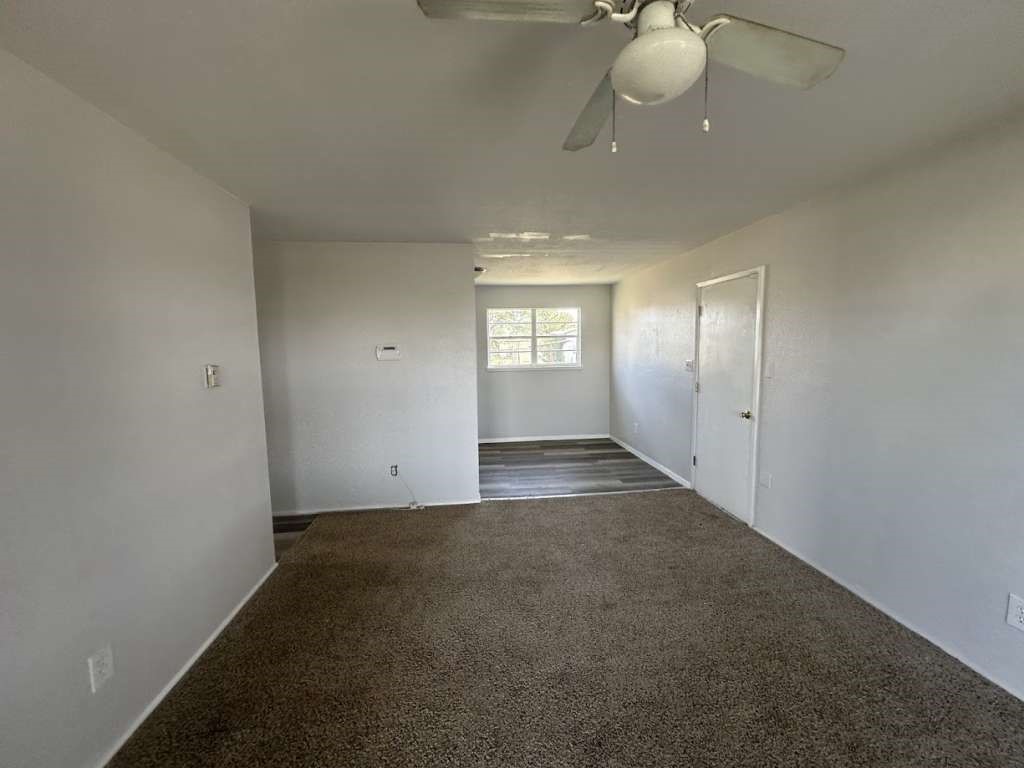 2424 East 28th Street Lubbock, TX 79404 - Photo 5 of 14 an empty room with windows and fan