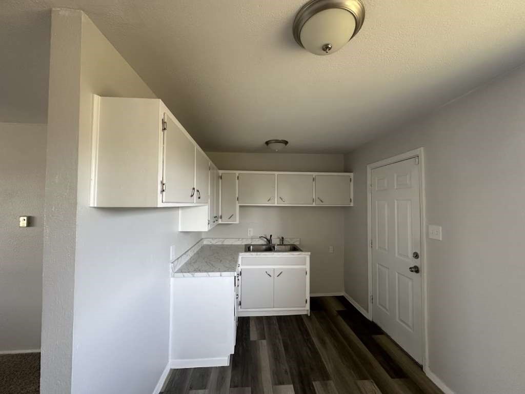 2424 East 28th Street Lubbock, TX 79404 - Photo 8 of 14 a kitchen with cabinets appliances and a window