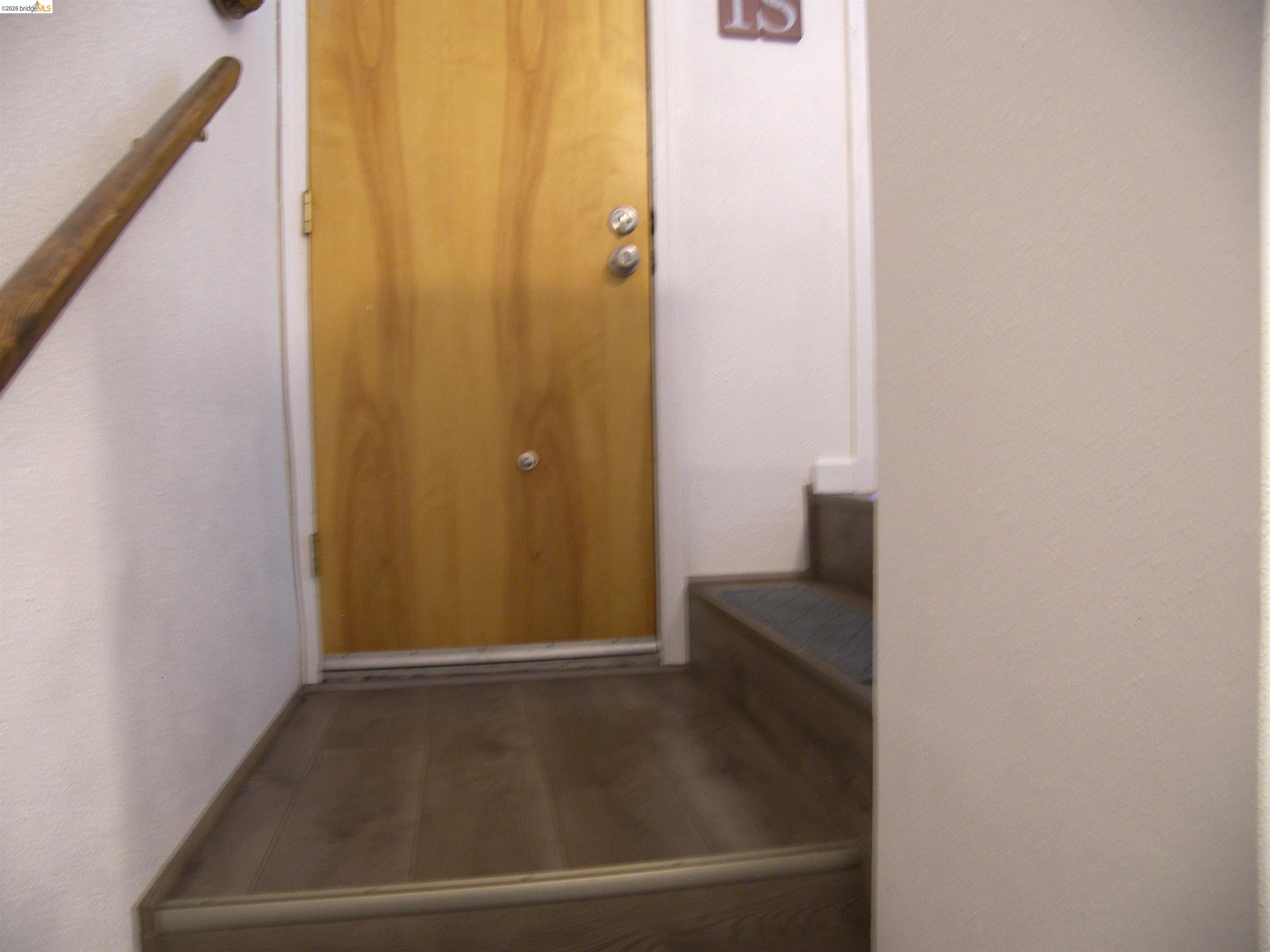 19215 Ferretti Road Groveland, CA 95321 - Photo 27 of 40 Wood-finish flooring and a natural wood door to garage.