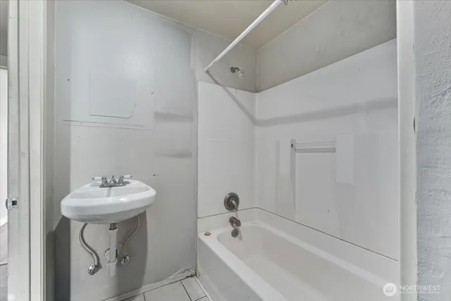 a bathroom with a sink a mirror and a bathtub