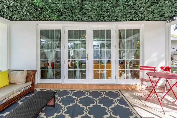 a backyard of a house with outdoor seating