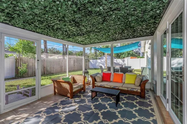 a view of a patio with table and chairs with wooden floor and fence