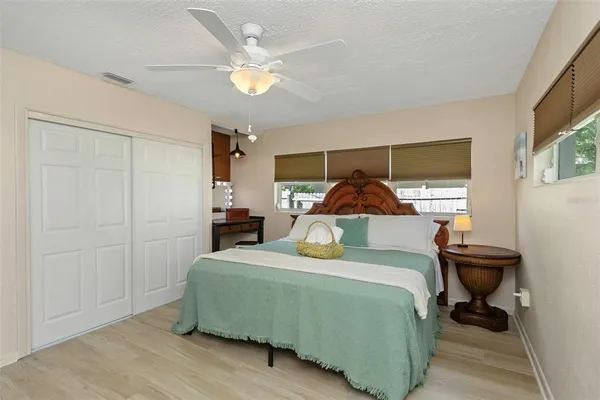 a bathroom with a granite countertop toilet sink and mirror