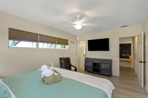 a bedroom with a bed and a chandelier