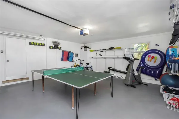 an aerial view of a house with a yard basket ball court and outdoor seating