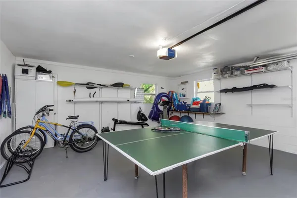 an aerial view of a house with a yard and lake view