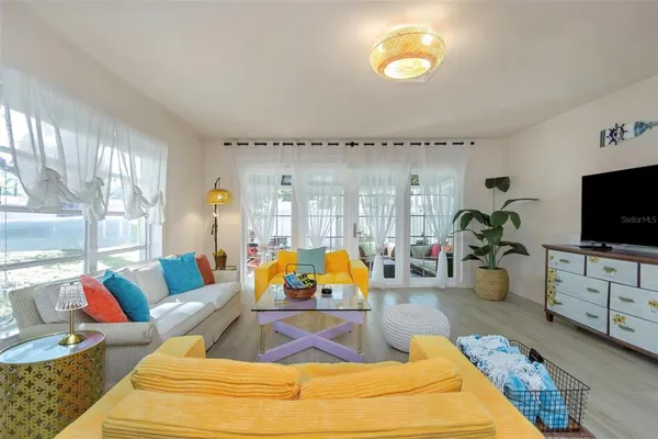 a living room with furniture and a wooden floor