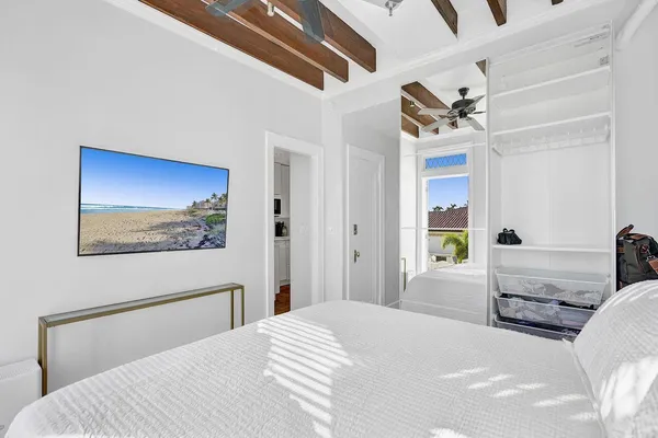 a bedroom with a bed and a painting on the wall