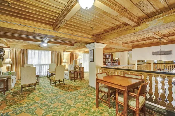 a lobby with furniture and chandelier