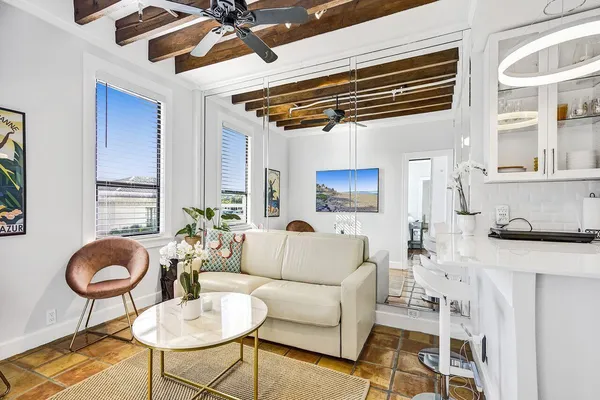 a living room with furniture and a lamp