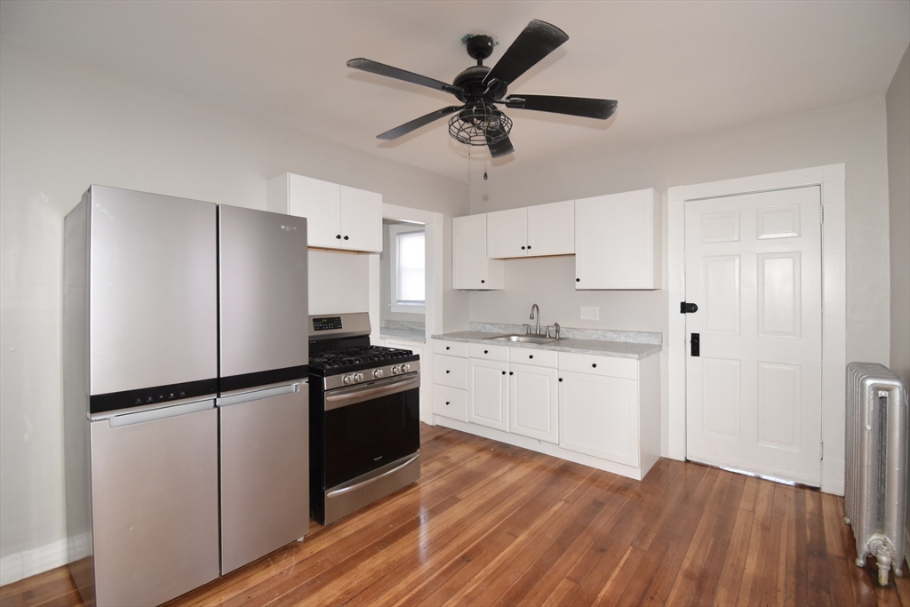34 Castle Street Springfield, MA 01118 - Photo 13 of 29 a kitchen with granite countertop a refrigerator a sink and dishwasher
