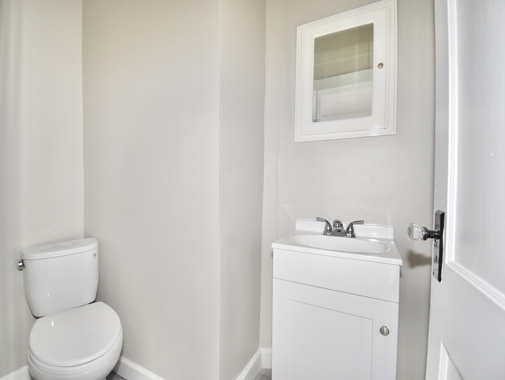 34 Castle Street Springfield, MA 01118 - Photo 19 of 29 a bathroom with a toilet sink and mirror