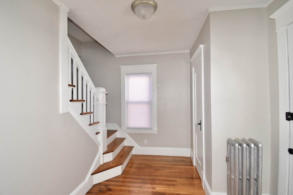 34 Castle Street Springfield, MA 01118 - Photo 5 of 29 a view of entryway with wooden floor and stairs