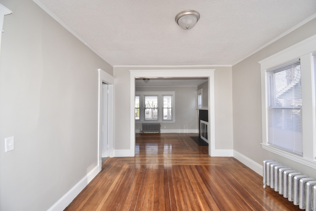 34 Castle Street Springfield, MA 01118 - Photo 7 of 29 a view of empty room with wooden floor and fan