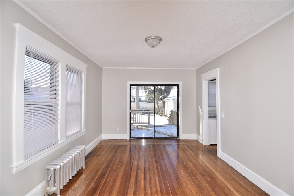 34 Castle Street Springfield, MA 01118 - Photo 9 of 29 a view of an empty room with wooden floor and a window