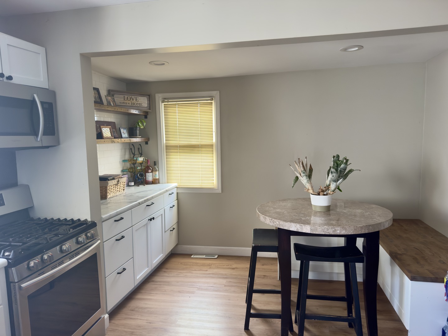 82 North 23rd Road Peru, IL 61354 - Photo 5 of 14 a kitchen with stainless steel appliances granite countertop a table chairs in it and a window