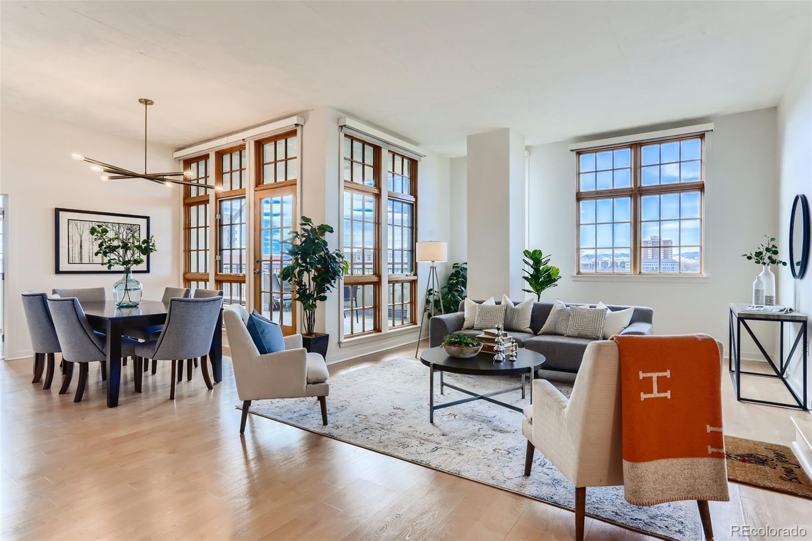 a living room with furniture a chandelier and a window