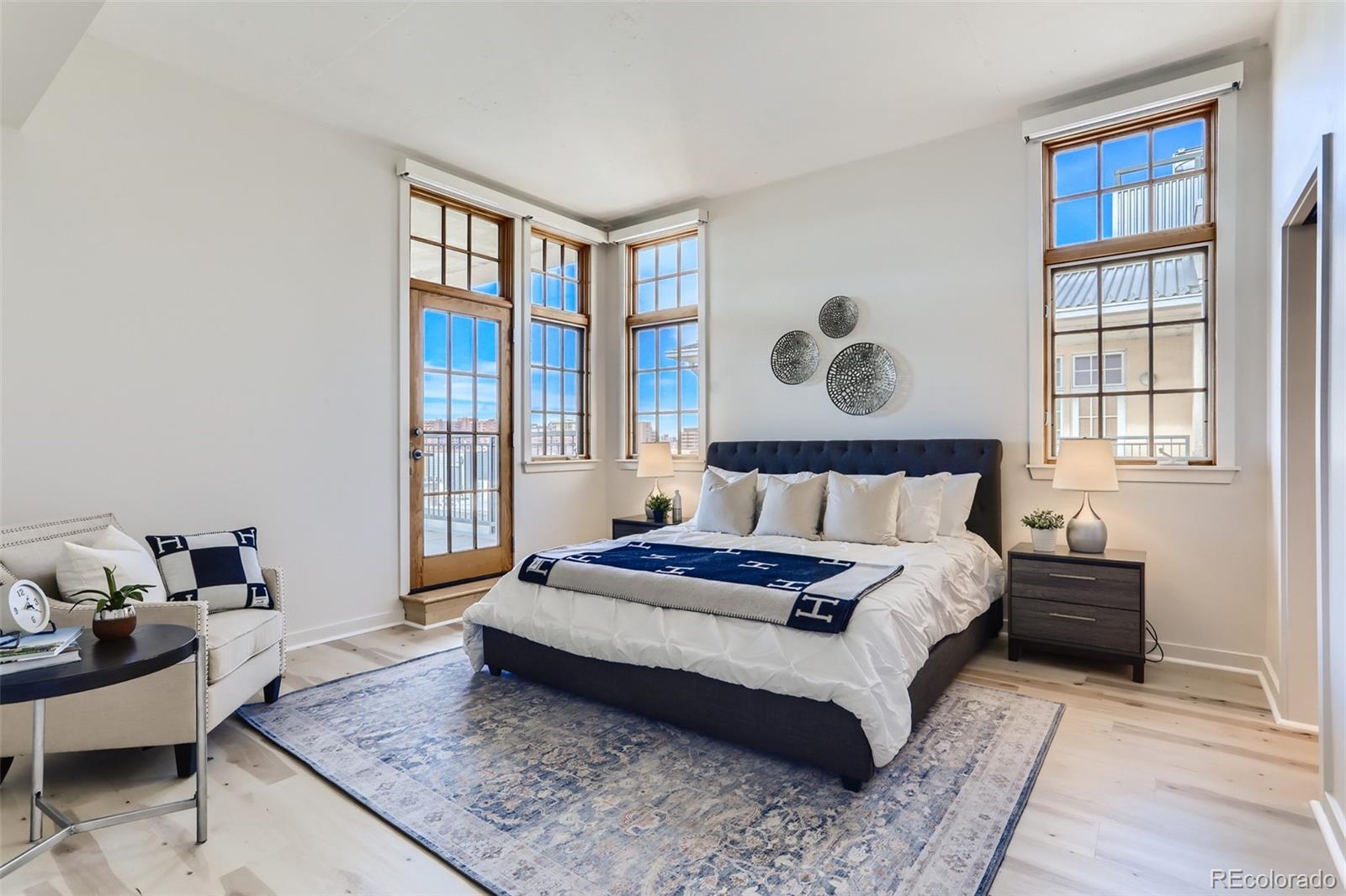 275 South Harrison Street, Unit 602 Denver, CO 80209 - Photo 14 of 33 a spacious bedroom with a bed and wooden floor