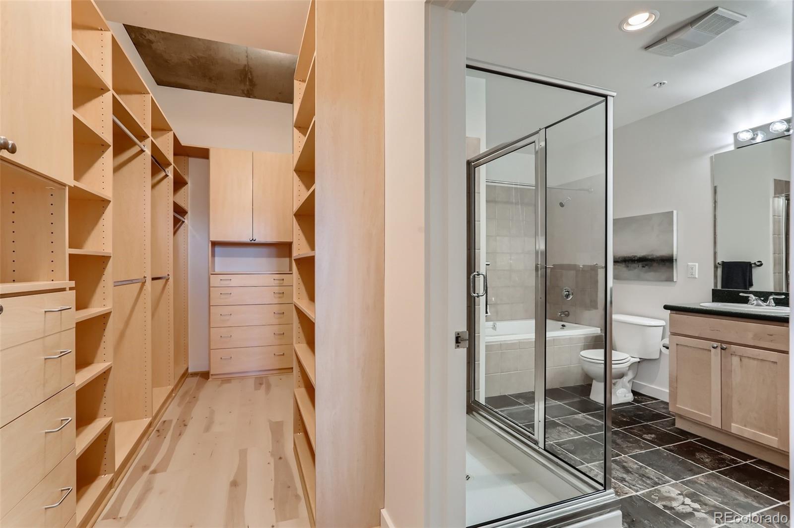 275 South Harrison Street, Unit 602 Denver, CO 80209 - Photo 17 of 33 a bathroom with a double vanity sink toilet and shower