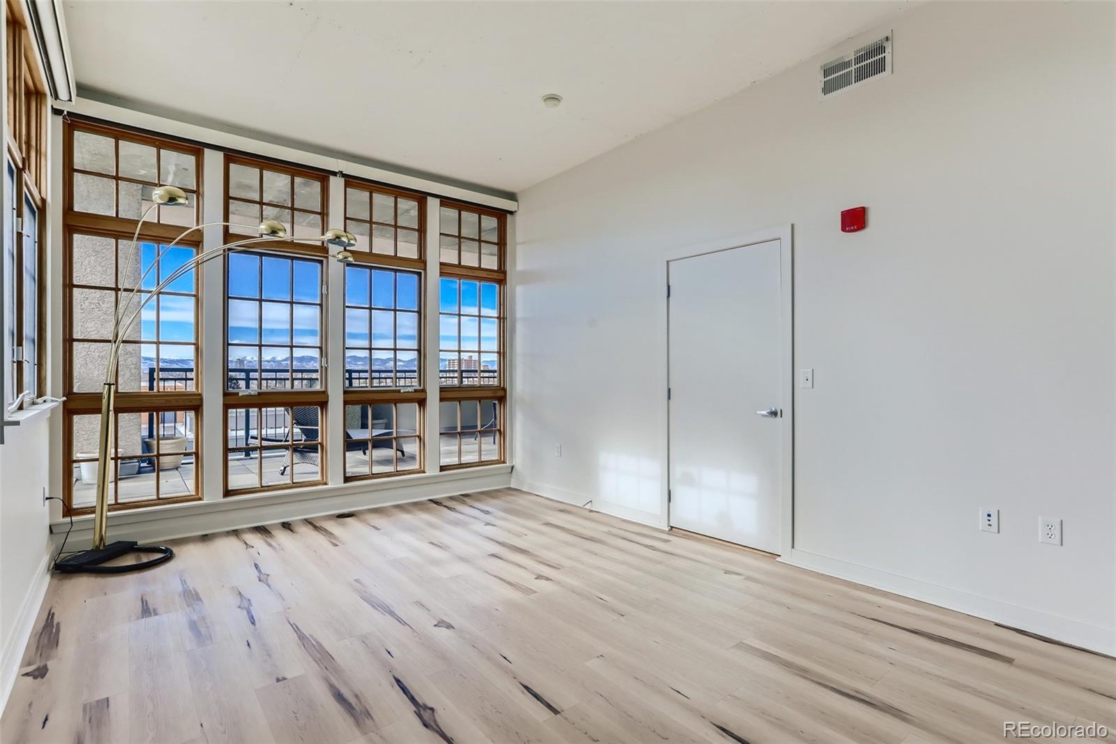 275 South Harrison Street, Unit 602 Denver, CO 80209 - Photo 19 of 33 a view of an empty room with wooden floor and a window