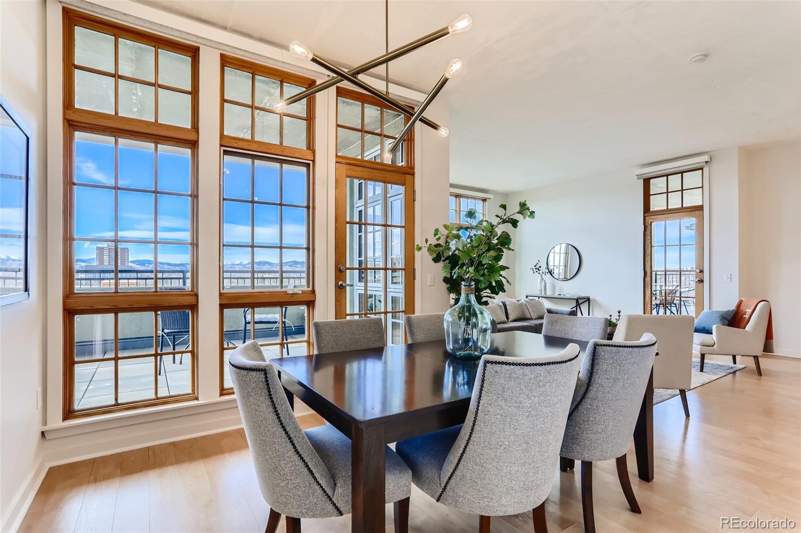 275 South Harrison Street, Unit 602 Denver, CO 80209 - Photo 7 of 33 a view of a dining room with furniture window and wooden floor