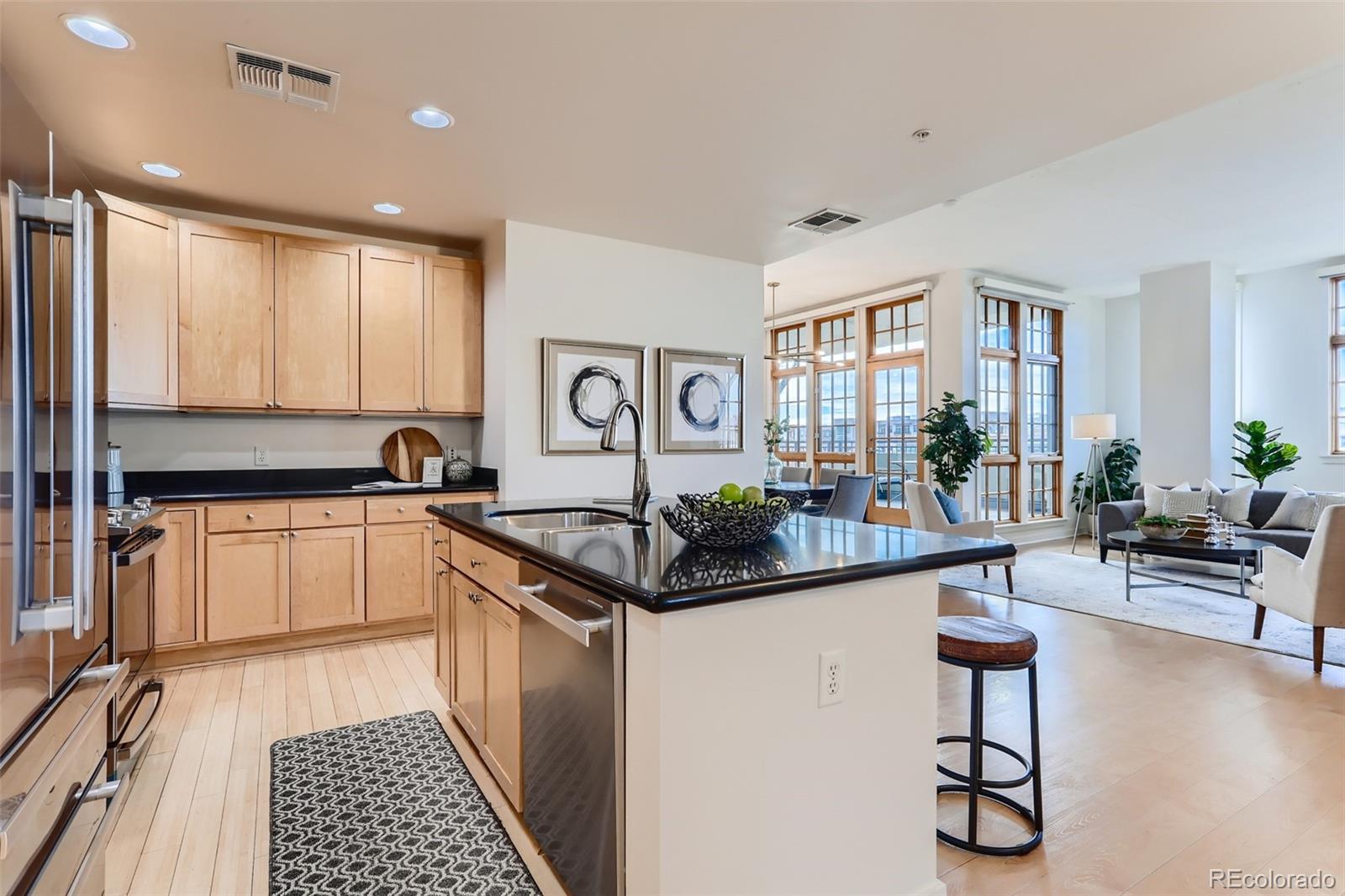 275 South Harrison Street, Unit 602 Denver, CO 80209 - Photo 9 of 33 a kitchen with stainless steel appliances granite countertop a stove and cabinets