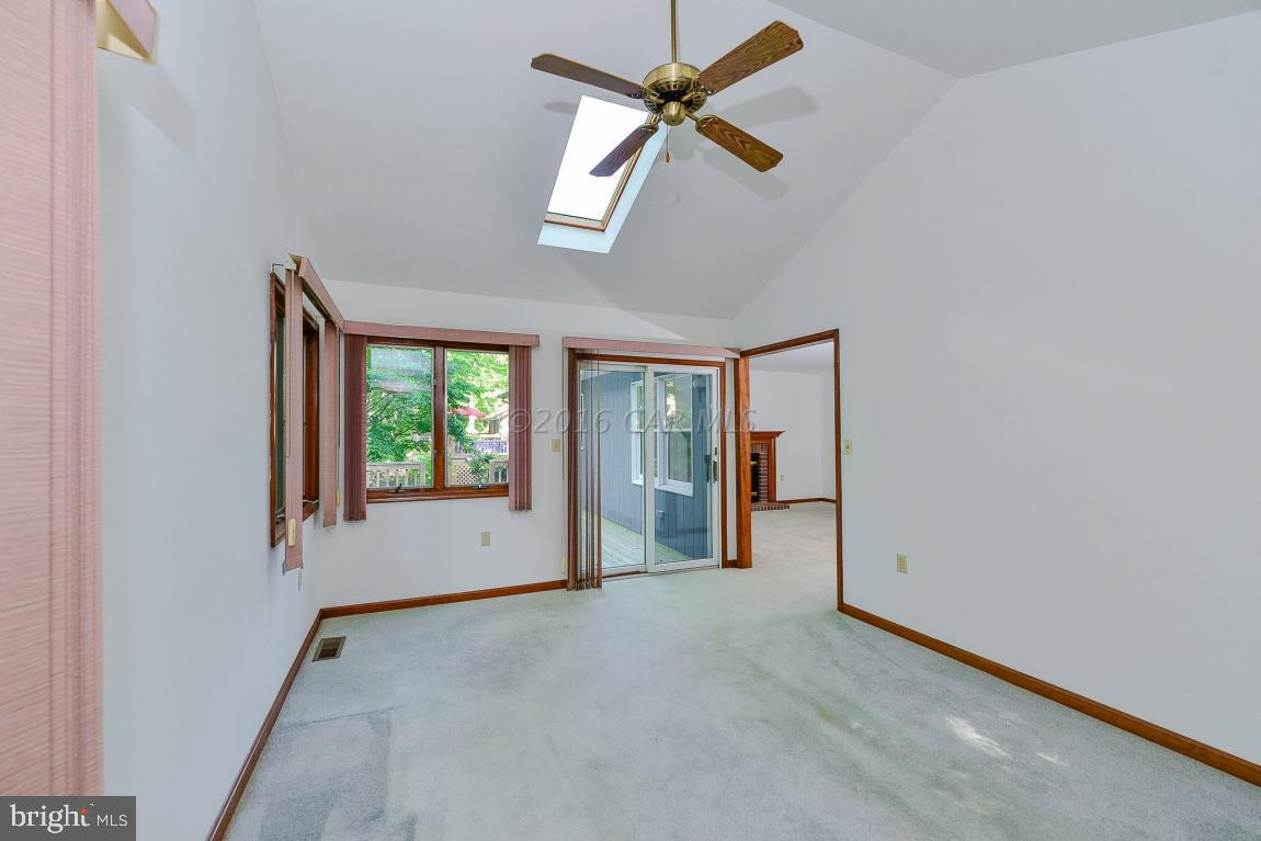 241 Windjammer Road Berlin, MD 21811 - Photo 17 of 38 an empty room with ceiling fan and windows