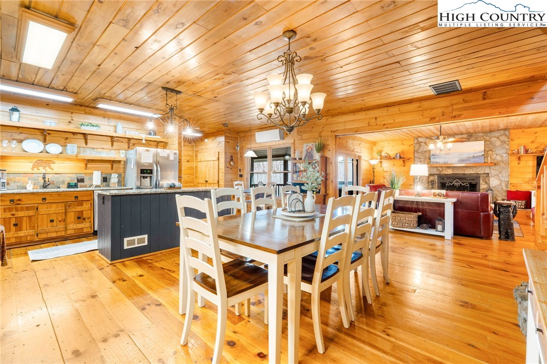 1748 Junaluska Road Boone, NC 28607 - Photo 19 of 37 a dining room with stainless steel appliances kitchen island granite countertop a table and chairs