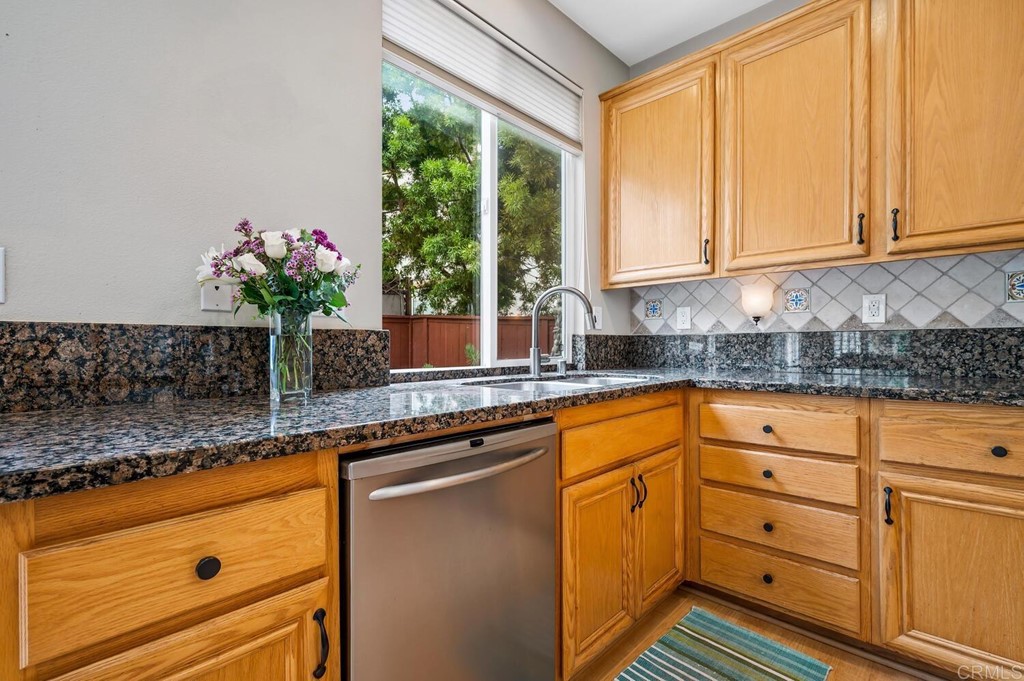 533 Anchorage Avenue Carlsbad, CA 92011 - Photo 11 of 58 a kitchen with granite countertop white cabinets and white stainless steel appliances