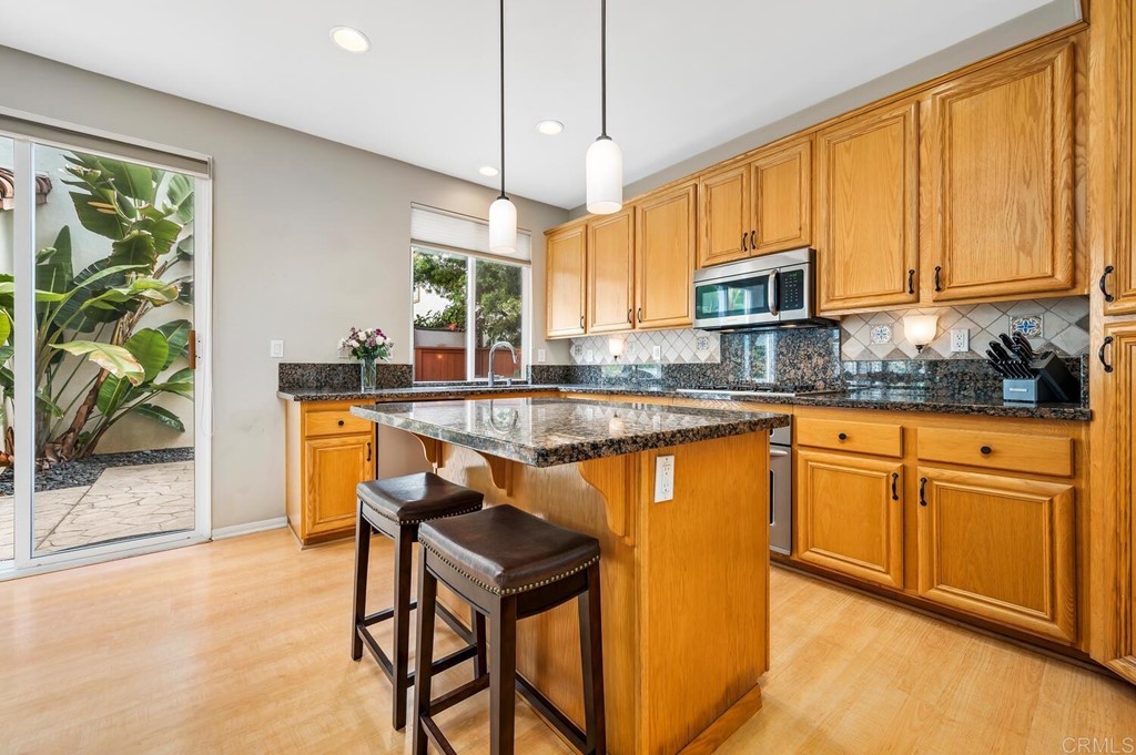 533 Anchorage Avenue Carlsbad, CA 92011 - Photo 12 of 58 a kitchen with stainless steel appliances granite countertop sink stove and refrigerator