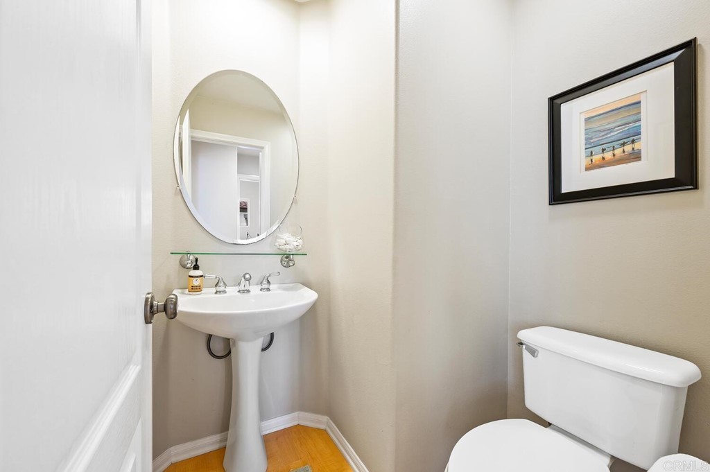 533 Anchorage Avenue Carlsbad, CA 92011 - Photo 15 of 58 a bathroom with a toilet sink and mirror