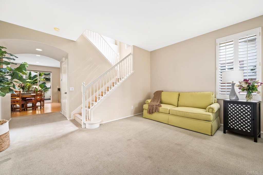 533 Anchorage Avenue Carlsbad, CA 92011 - Photo 17 of 58 a living room with furniture and a dining table with wooden floor