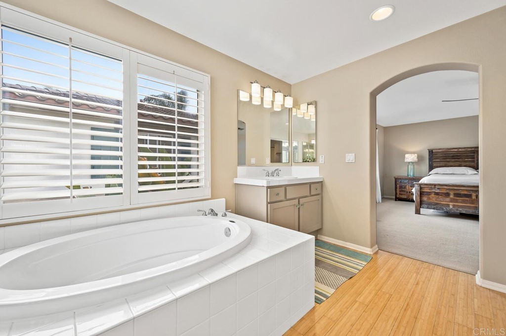 533 Anchorage Avenue Carlsbad, CA 92011 - Photo 24 of 58 a spacious bathroom with a granite countertop tub next to a large window