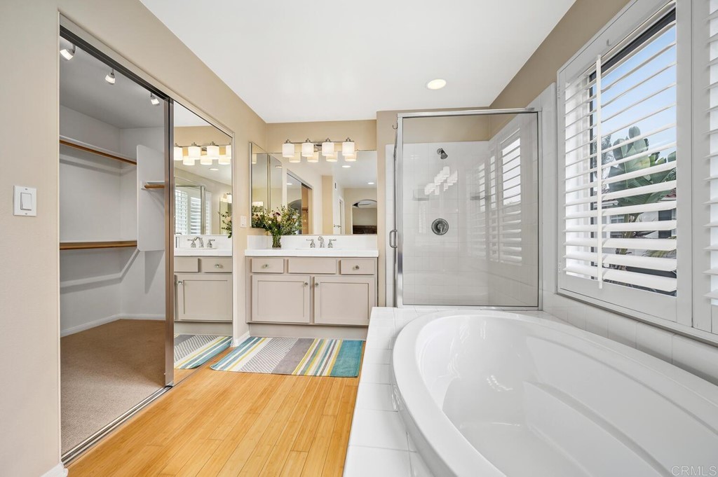 533 Anchorage Avenue Carlsbad, CA 92011 - Photo 25 of 58 a spacious bathroom with a tub sink and mirror