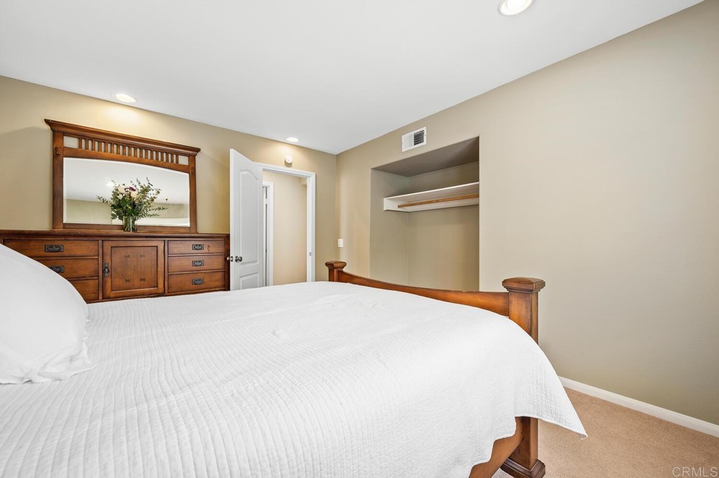 533 Anchorage Avenue Carlsbad, CA 92011 - Photo 29 of 58 a bedroom with a large bed and dresser