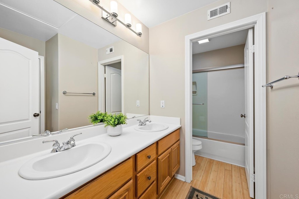 533 Anchorage Avenue Carlsbad, CA 92011 - Photo 30 of 58 a bathroom with a granite countertop sink and a mirror