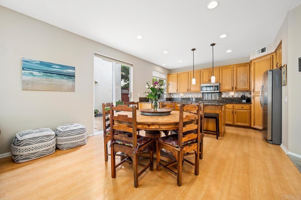 533 Anchorage Avenue Carlsbad, CA 92011 - Photo 8 of 58 a view of a dining room with furniture window and wooden floor