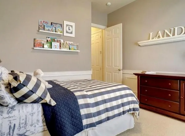 a bedroom with a bed and a dresser